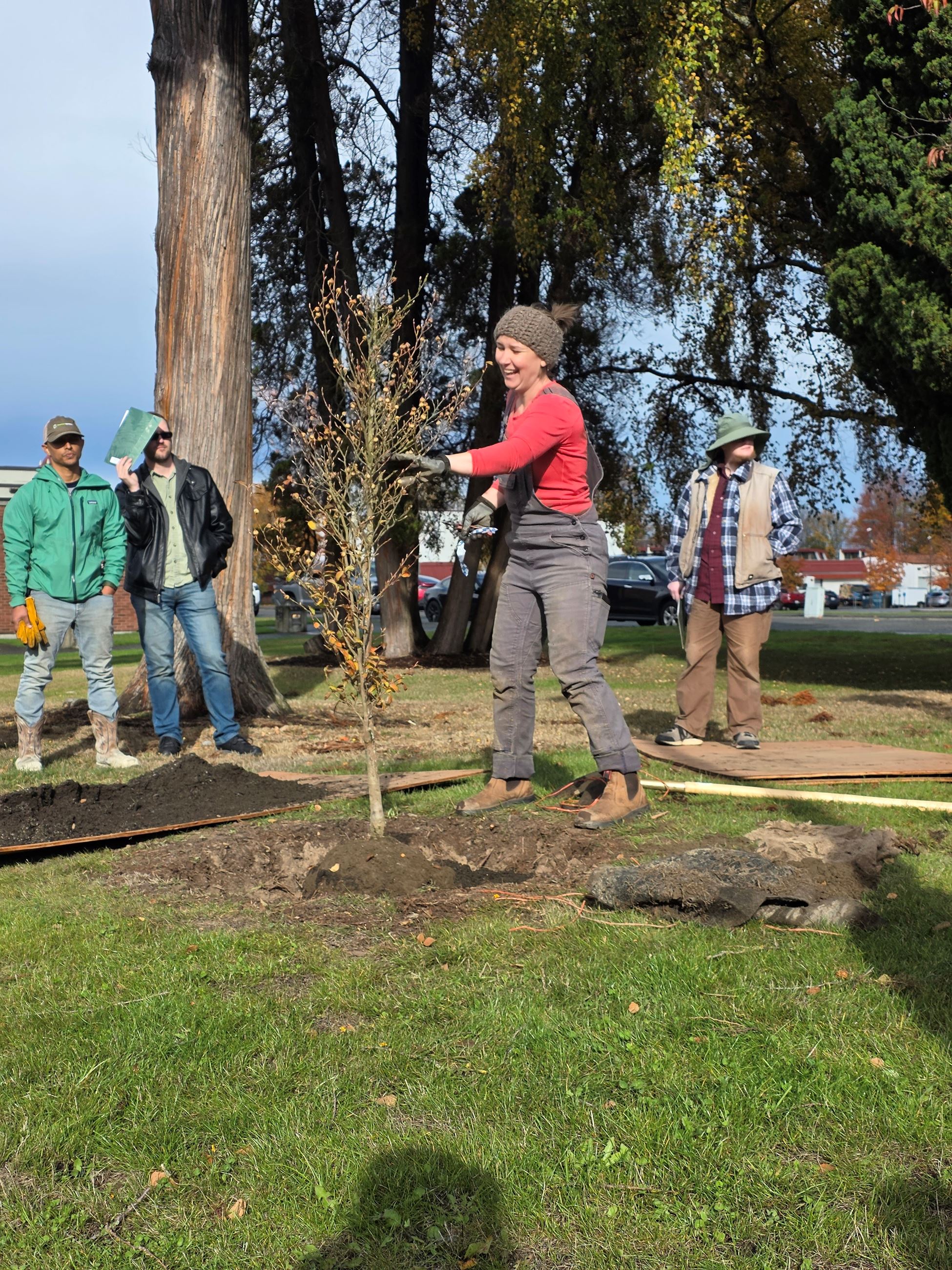 Natural Resources Administrator Courtney Bornsworth offers tree planting techniques